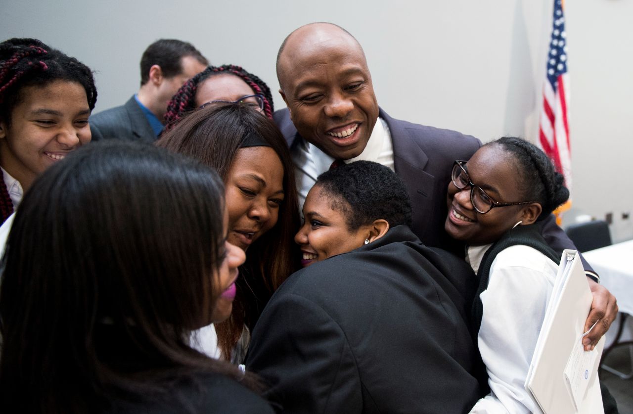 Scott hugs a group of students visiting Washington, DC, in February 2015.