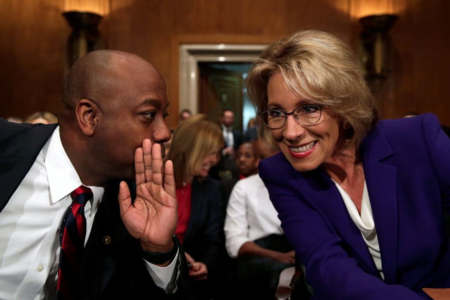 Scott chats with Betsy DeVos at her confirmation hearing to become the next education secretary in January 2017.