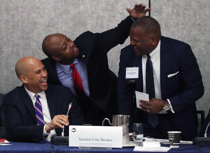 From left, US Sens. Cory Booker and Scott joke with Columbia Mayor Steve Benjamin during an economics session for the US Conference of Mayors in January 2018.