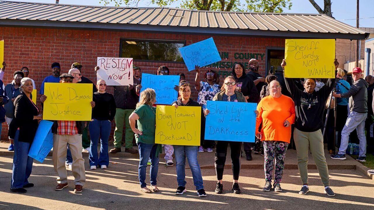 McCurtain County residents demonstrate in Idabel, Oklahoma, on Monday to call for the resignation of several county officials after the recording was made public.