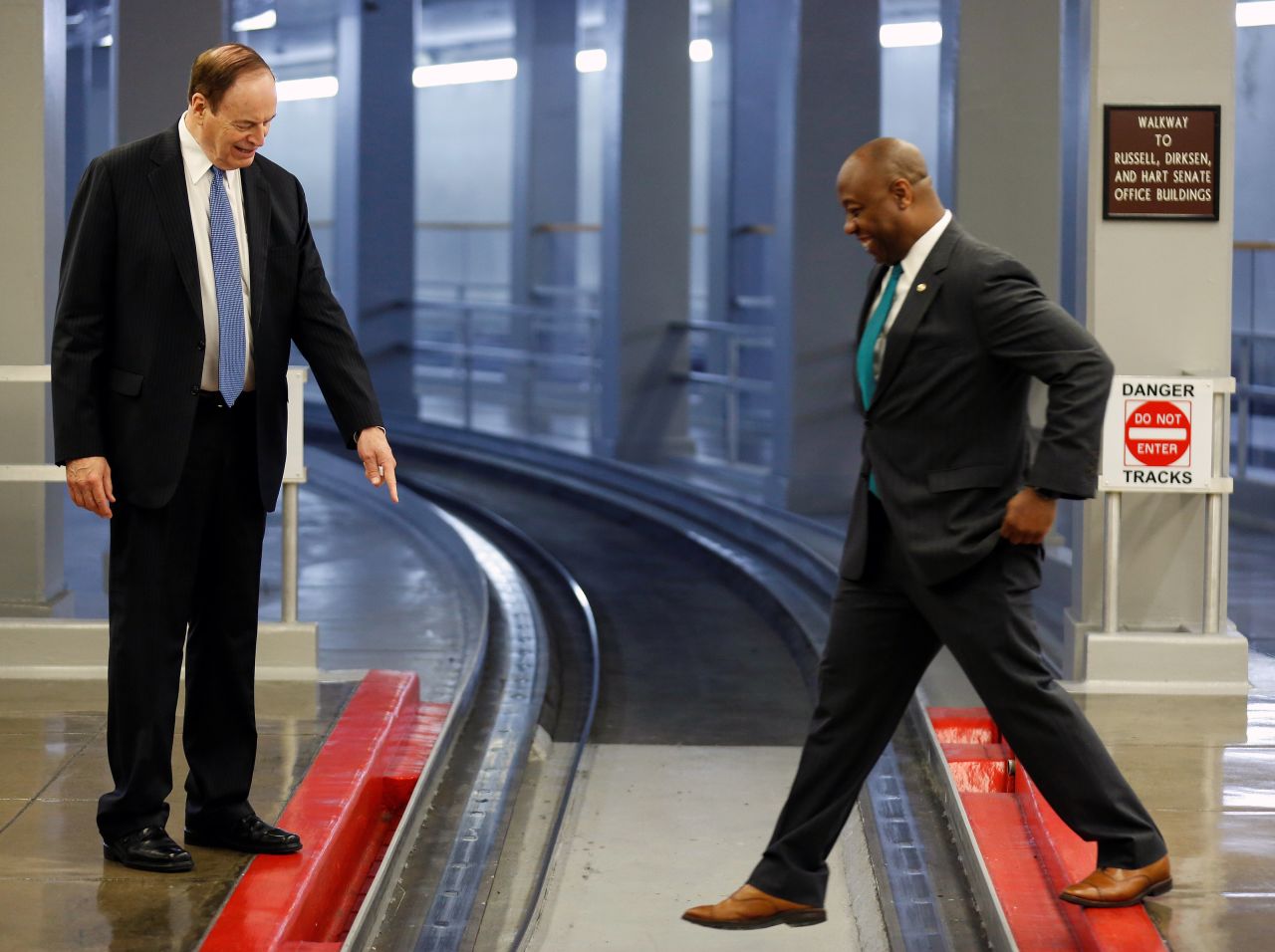 US Sen. Richard Shelby points to an electrified rail as Scott steps across the Senate subway track in August 2018.