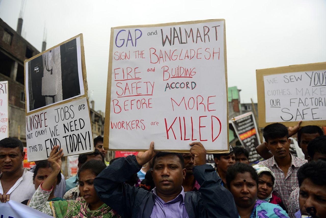Reatives of Bangladeshi workers who lost their lives in the Rana Plaza collapse gather with banners and placards in Savar on June 29, 2013, at the site of Bangladesh's worst industrial disaster.