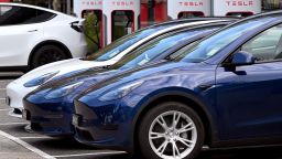Electric vehicles (EV) line up outside a Tesla dealership in Melbourne on April 19, 2023. 