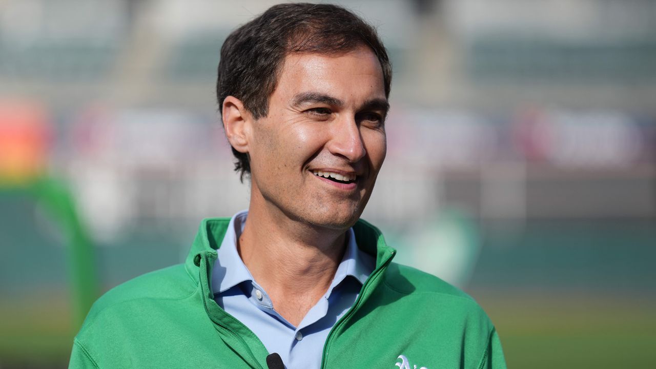 Oakland Athletics president Dave Kaval talks on the field before the game against the Minnesota Twins at RingCentral Coliseum.