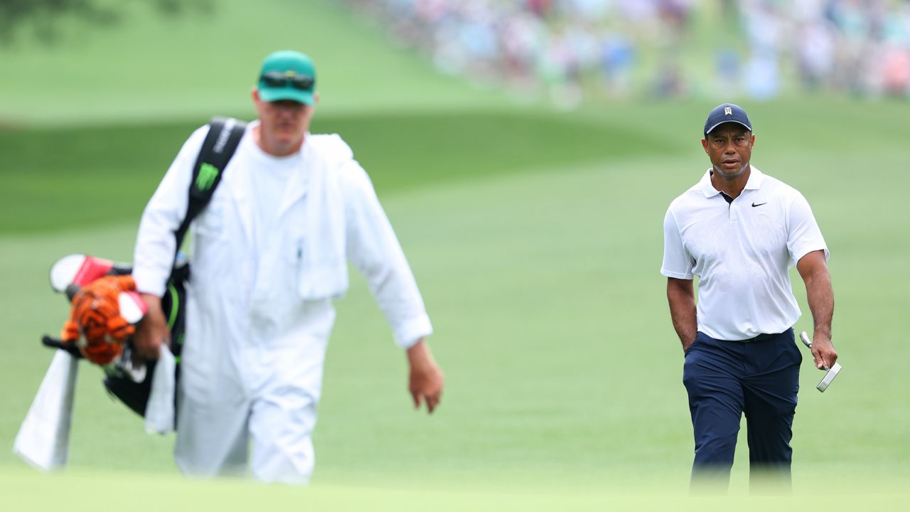 Woods walks with his caddie Joe LaCava during the first round of The Masters.