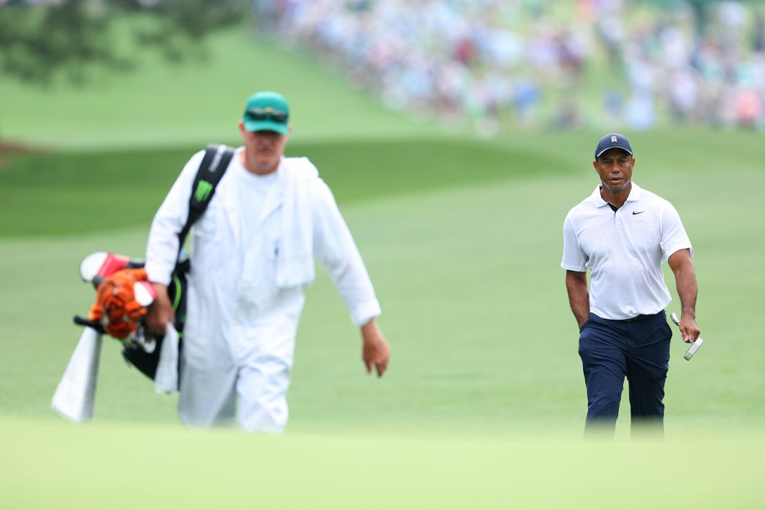 Woods walks with his caddie Joe LaCava during the first round of The Masters.