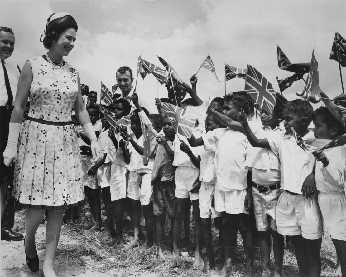 Queen Elizabeth II is greeted by local children at Cooktown in Queensland, during her tour of Australia, 22nd April 1970. She is there in connection with the bicentenary of Captain Cook's 1770 expedition to Australia. A memorial stone is being unveiled to mark the spot where Cook's ship 'The Endeavour' was beached for repairs. (Photo by Central Press/Hulton Archive/Getty Images)