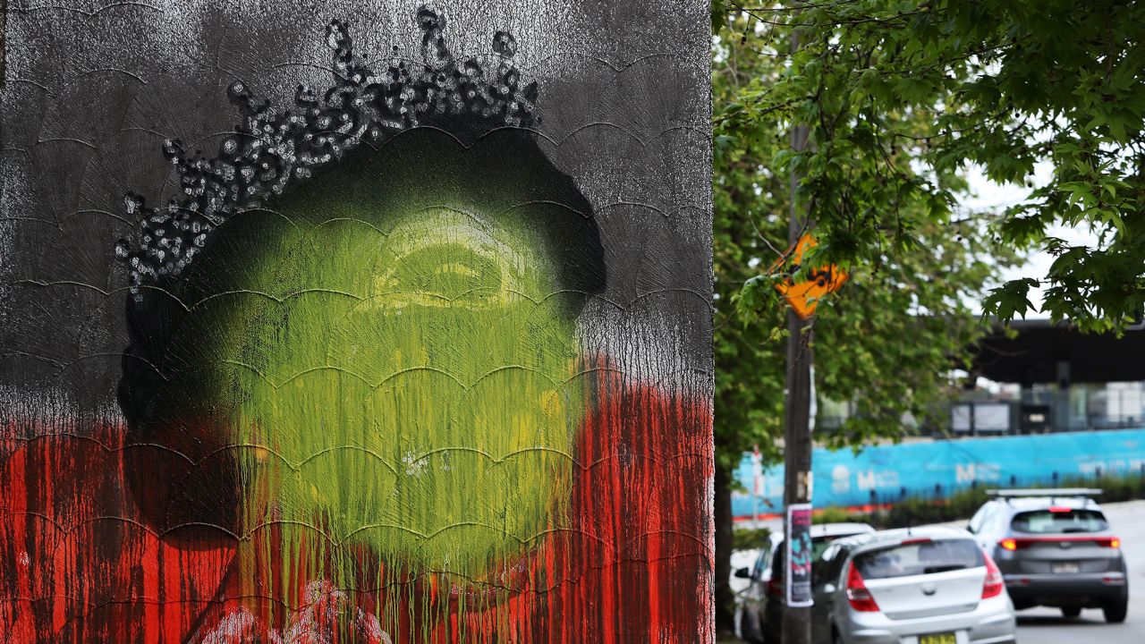 SYDNEY, AUSTRALIA - SEPTEMBER 22: A mural of the late Queen Elizabeth II by artist Stuart Sale has been painted over with the colours of the Aboriginal flag in Marrickville Thursday 22 September was declared a one-off public holiday as a National Day of Mourning for Australia following Queen Elizabeth II's death. (Photo by Lisa Maree Williams/Getty Images)