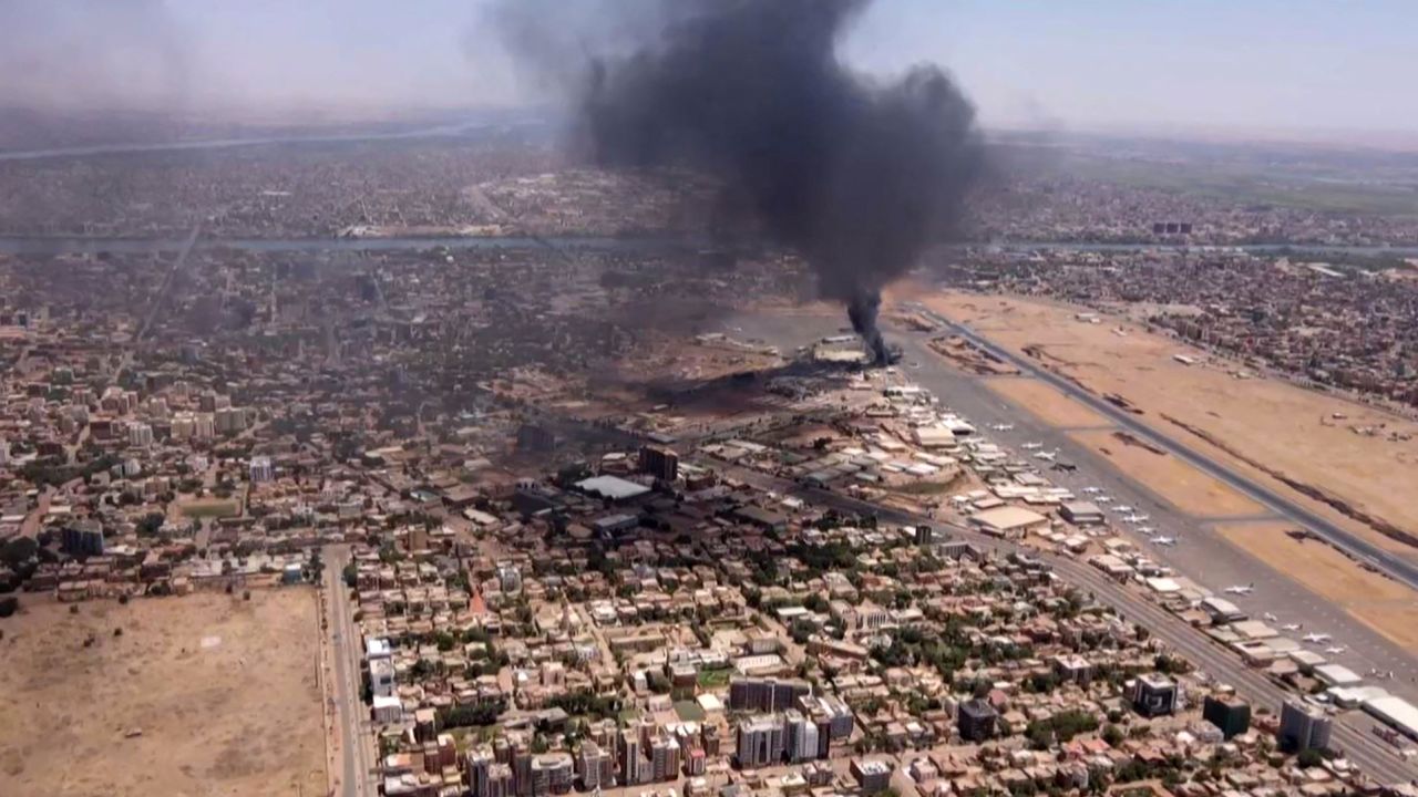 An aerial view shows black smoke rising above the Khartoum International Airport in Khartoum, Sudan, on April 20, 2023.