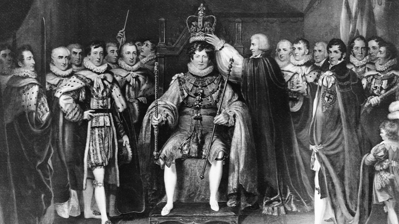 Courtiers stand beside and place the crown on King George IV, who was King of England from 1820-1830.