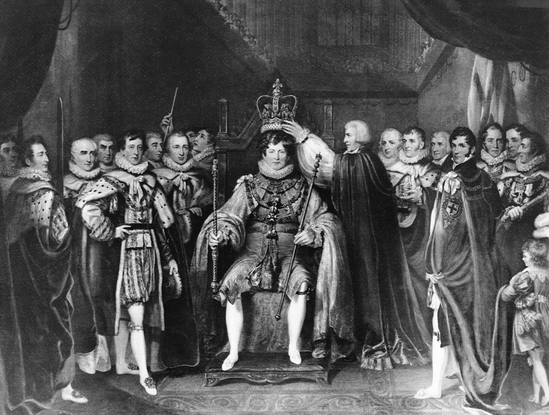 Courtiers stand beside and place the crown on King George IV, who was King of England from 1820-1830. 