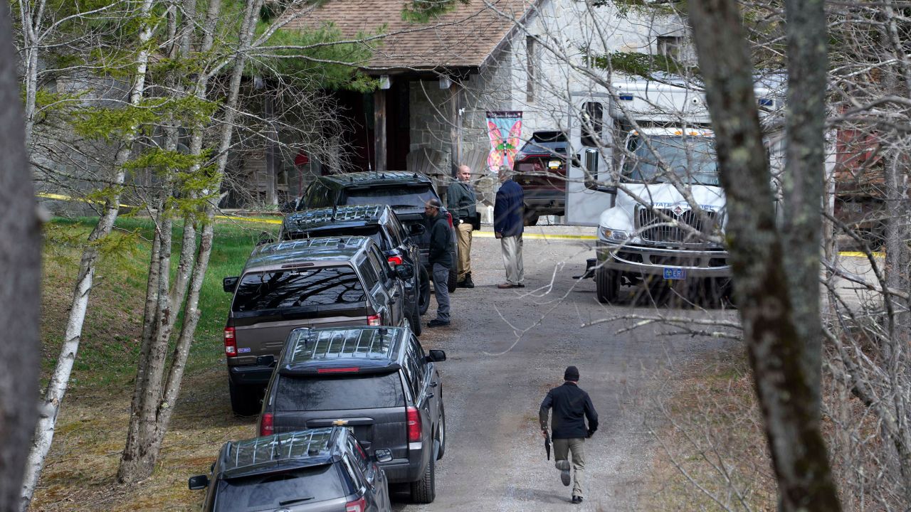 Investigators work at the scene of a deadly shooting, Tuesday, April 18, 2023, in Bowdoin, Maine. State police say gunfire that erupted on busy highway is linked to a second crime scene where four people were found dead in a home about 25 miles away. 