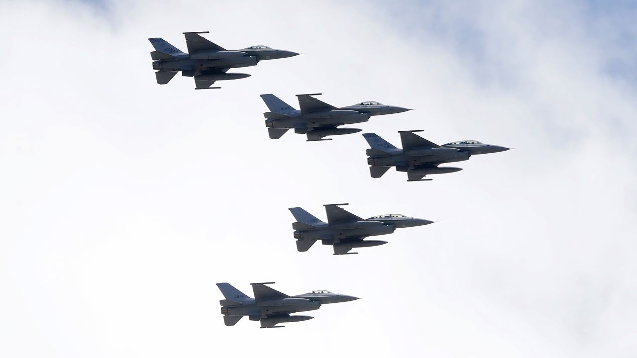 Taiwan's F-16 fighter jets fly in close formation over President Office during National Day celebrations in front of the Presidential Building in Taipei, Taiwan, Oct. 10, 2021.