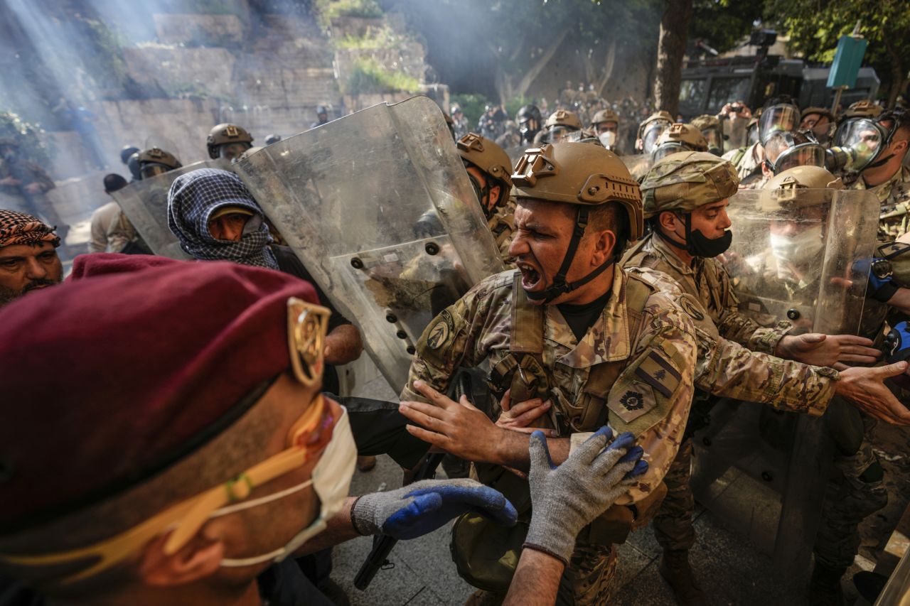 Protesters scuffle with members of the Lebanese army as they advance toward government buildings in Beirut on Tuesday, April 18. Earlier in the day, Lebanon's Parliament voted to postpone municipal elections in the country, which has been in a <a href="https://www.cnn.com/2022/09/22/asia/lebanon-banks-shut-holdups-intl/index.html" target="_blank">financial crisis</a> since 2019.