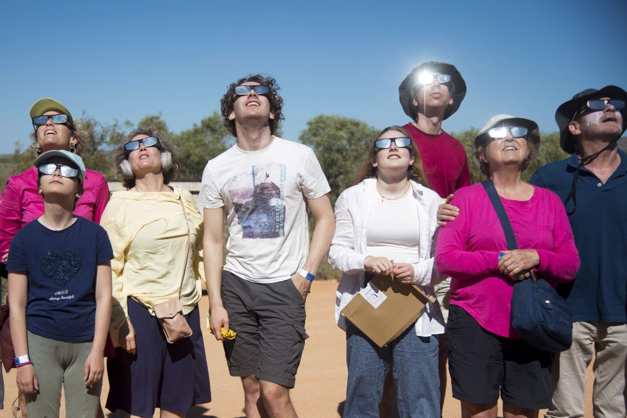 People watch a hybrid solar eclipse in Exmouth, Australia, on Thursday, April 20. People from across the world traveled to Exmouth to observe the <a href="https://www.cnn.com/videos/travel/2023/04/20/hybrid-solar-eclipse-australia-lon-orig-ao.cnn" target="_blank">rare celestial event</a> — the first of its kind in nearly 10 years.