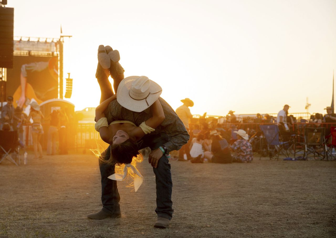 Julian Ballesteros and Kayley Gehrels dance during the Country Thunder music festival in Florence, Arizona, on Saturday, April 15.