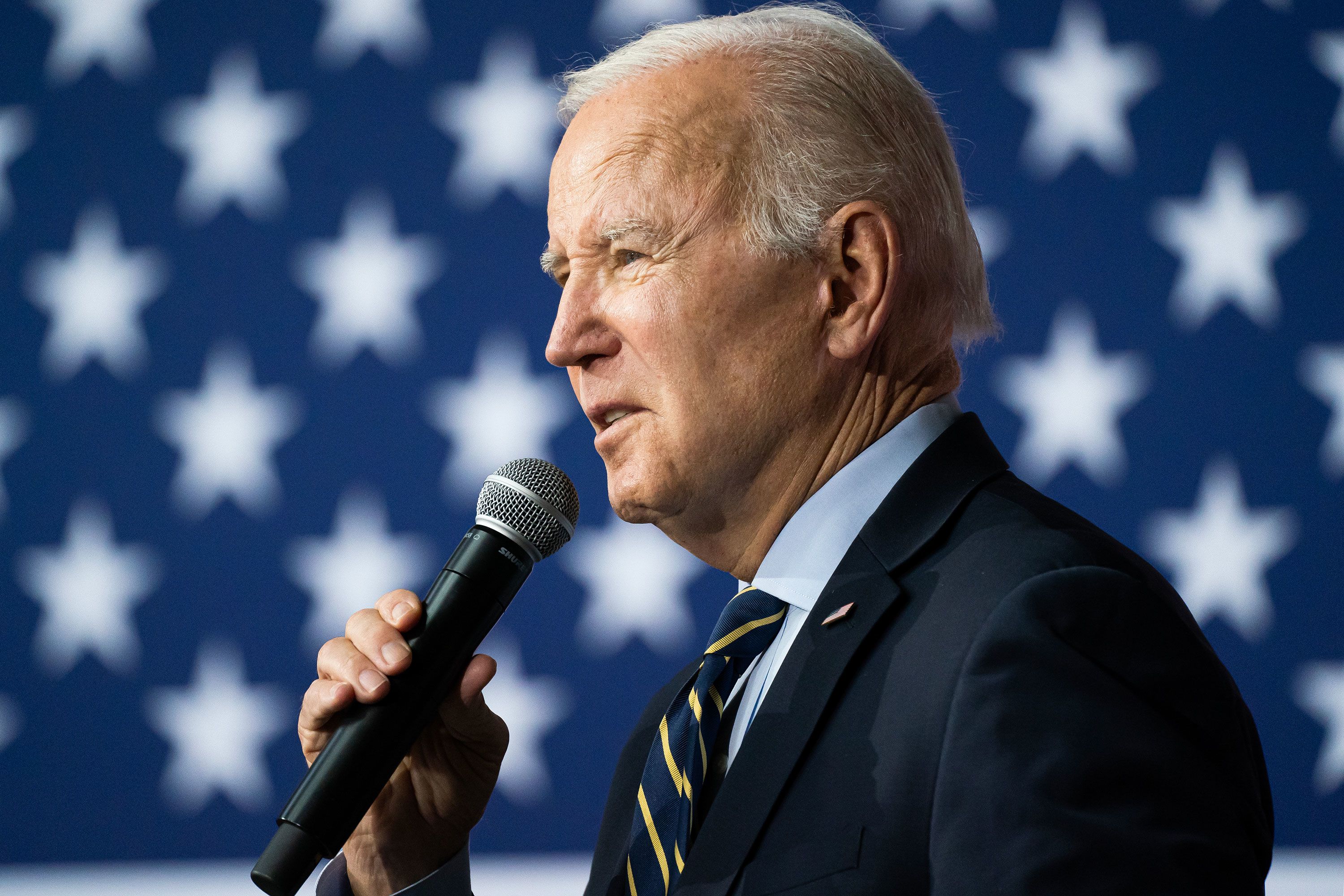 U.S. President Joe Biden holds a hockey jersey with his name on it