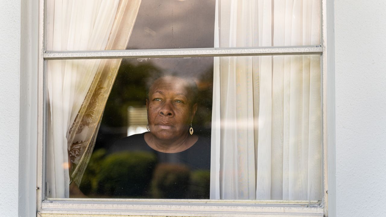 Marcia Williams looks out the window of her home in Naples. (Sydney Walsh for CNN)