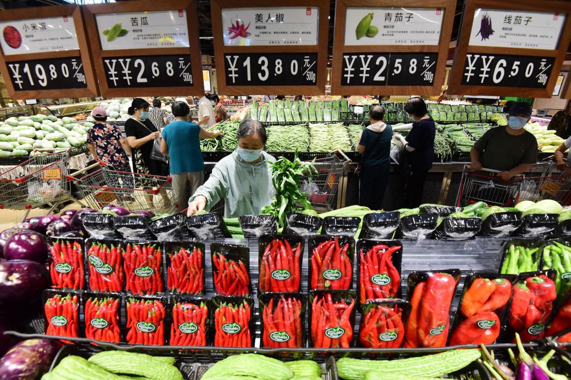 Customers shop for vegetables at a supermarket in July 2022 in China's Hebei province.