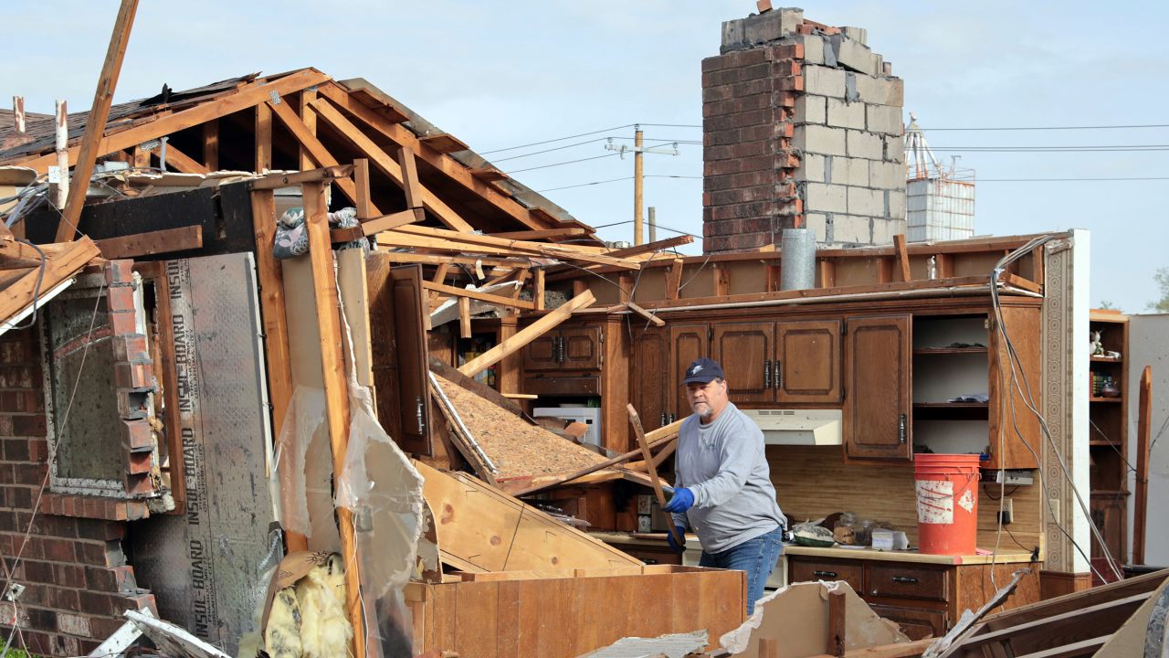 Kent Reynolds removes debris Thursday after a tornado hit his mother-in-law's house the prior day in Cole, Oklahoma.