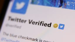 The gold checkmark on Twitter Verified account on Twitter is seen displayed on a phone screen in February 2023.