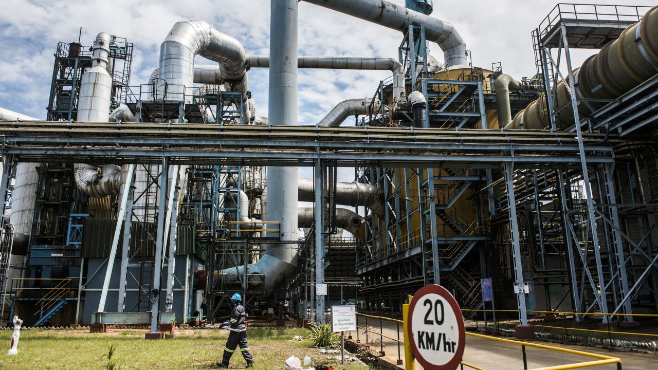 A mine worker walks past conveyors and pipe systems at the concentrator plant at the Nchanga copper mine operated by KCM in Chingola, Zambia.