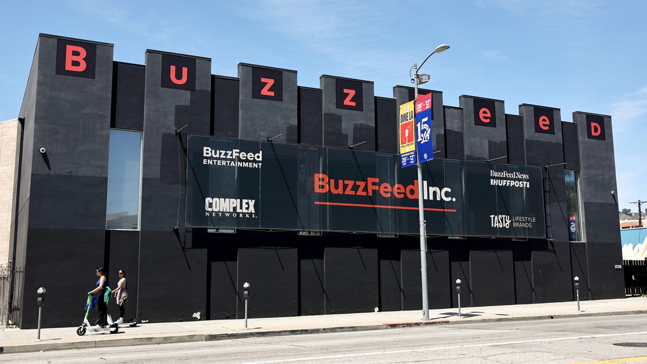People ride scooters past BuzzFeed offices in the Hollywood neighborhood on April 20, 2023 in Los Angeles, California. 