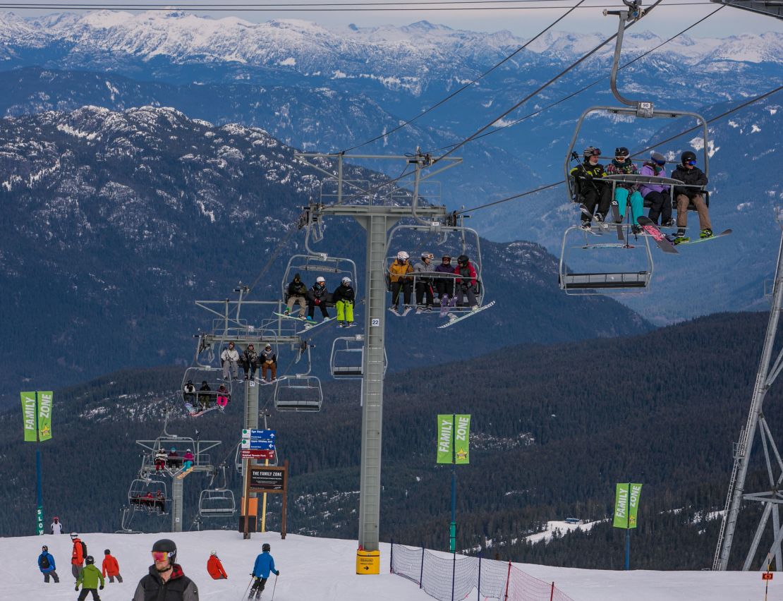 Skiers ride the main chair lift to the top of Whistler Mountain in British Columbia, Canada.  