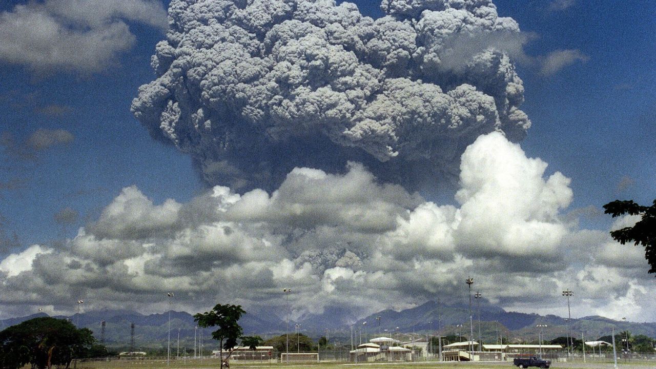 A giant mushroom cloud of steam and ash explodes out of Mt. Pinatubo in 1991. The eruption led to cooler temperatures.
