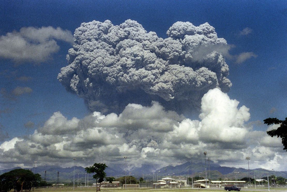 A giant mushroom cloud of steam and ash explodes out of Mt. Pinatubo in 1991. The eruption led to cooler temperatures.