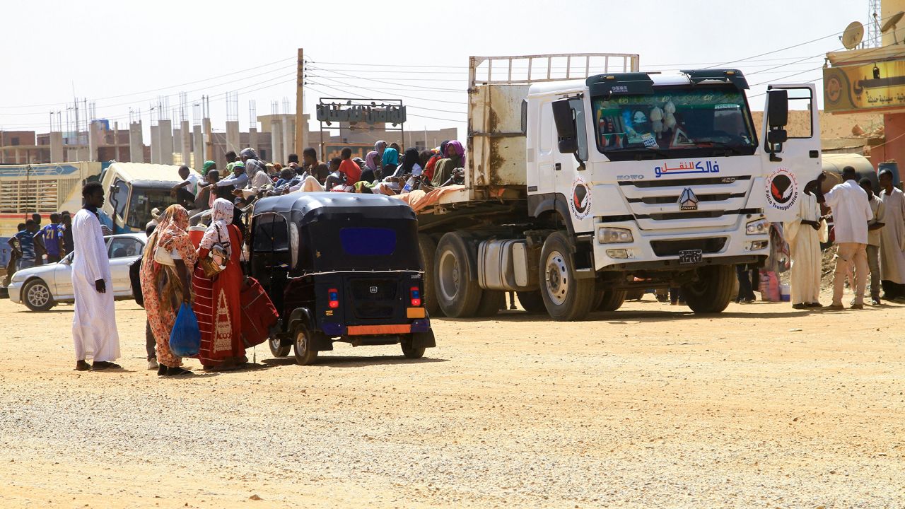 People flee the southern part of Sudan's capital as street battles between the forces of two rival Sudanese generals continue on April 21.