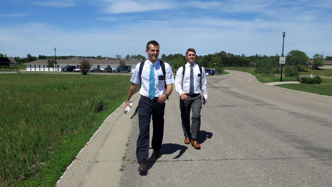 A pair of Mormon missionaries set off on foot in Detroit Lakes, Minnesota, in 2018. 