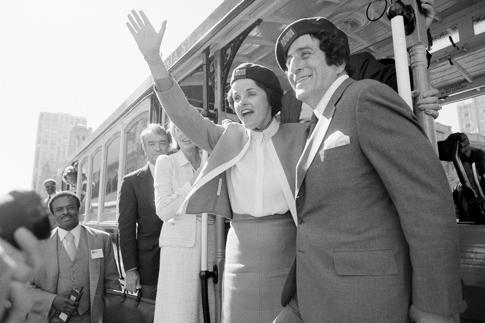 Feinstein and singer Tony Bennett wave from a cable car in San Francisco before taking a test ride in 1984.