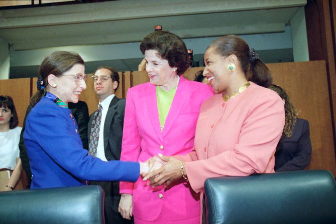 Feinstein looks on as Supreme Court nominee Judge Ruth Bader Ginsburg shakes hands with Sen. Carol Moseley-Braun prior to Ginsburg's confirmation hearing before the Senate Judiciary Committee on Capitol Hill in 1993.