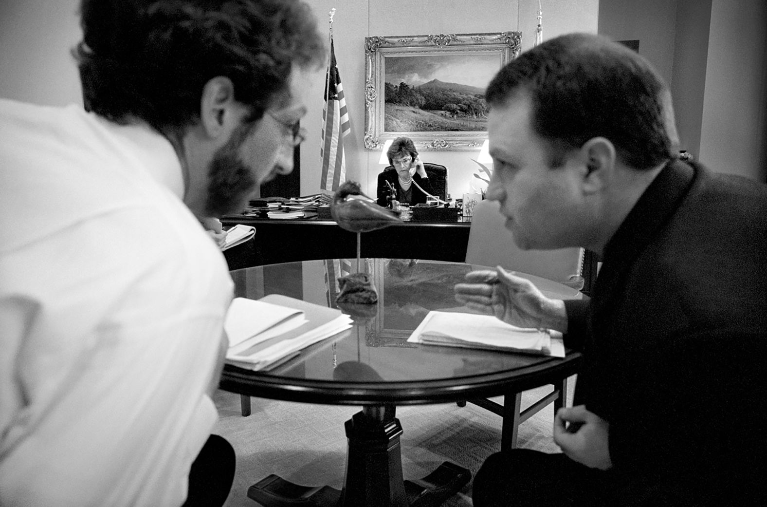 In 2003, Feinstein speaks to a fellow senator on the phone as two of her staffers talk in the foreground.