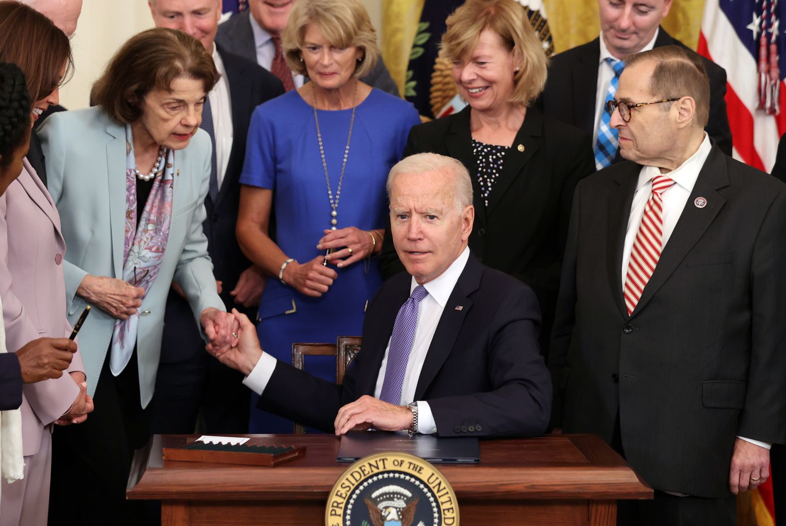 President Joe Biden holds Feinstein's hand after signing into law the Victims of Crime Act in the East Room at the White House in 2021.