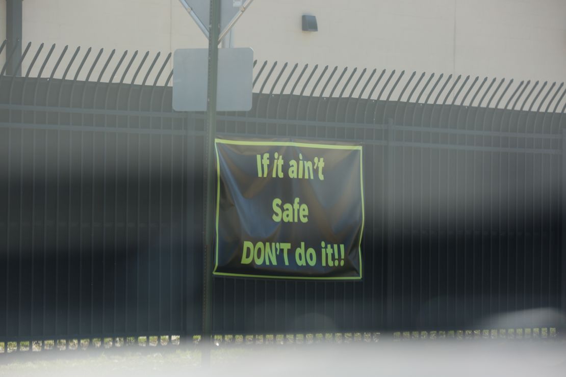 A safety sign hangs on a fence at a Tyson plant in Hope, Arkansas, in March 2023.
