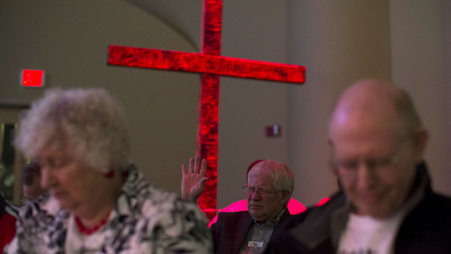 Attendees bow their heads in prayer at an Iowa Faith and Freedom Coalition forum in Waukee on April 25, 2015.