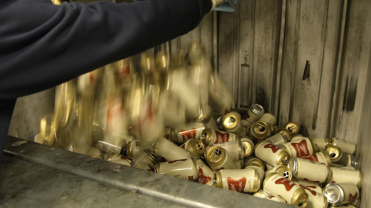 Belgian customs workers destroy more than 2,000 cans of Miller High Life advertised as the ″Champagne of beers"  at the Westlandia plant in Ypres, Belgium, on April 17, 2023.