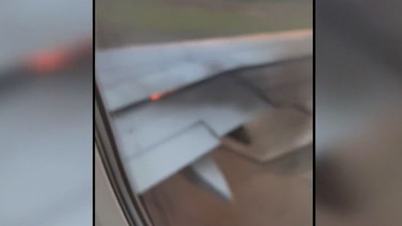Video shows flames shooting from wing of American Airlines plane on runway | CNN