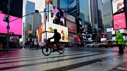 A man rides an e-bike through Times Square on February 21, 2023, in New York City. 