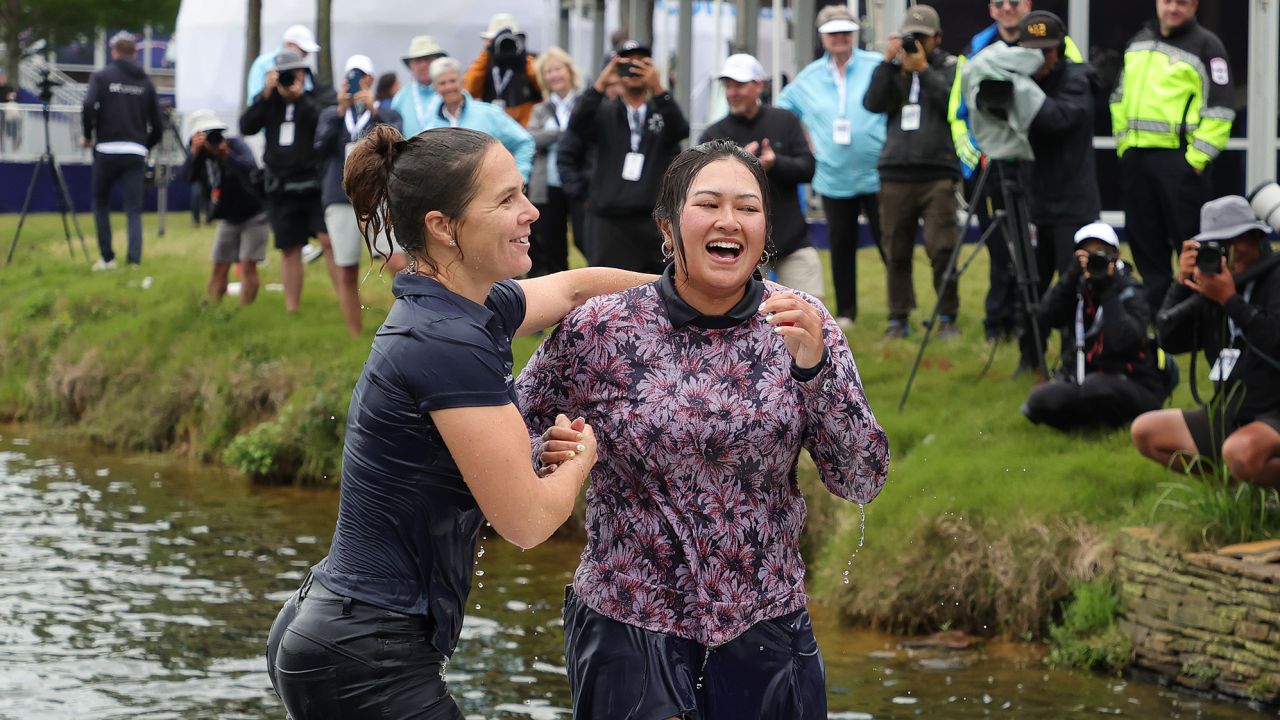 Wu (R) celebrates her victory in the water.