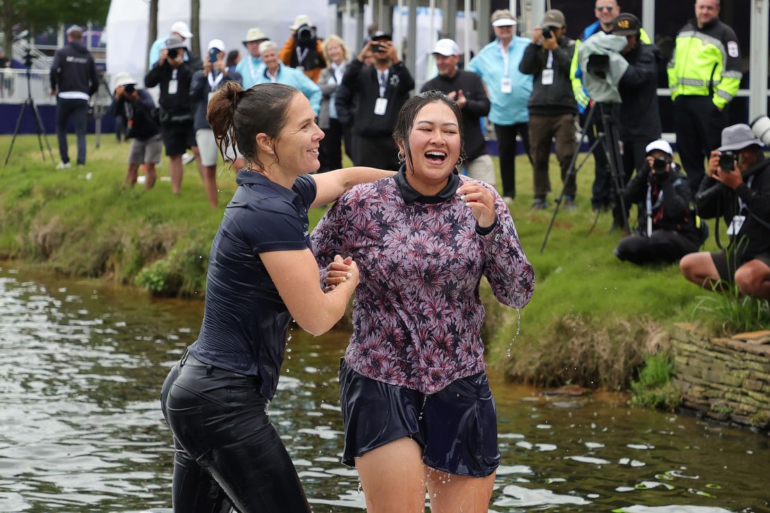 Vu (R) celebrates her win in the water.