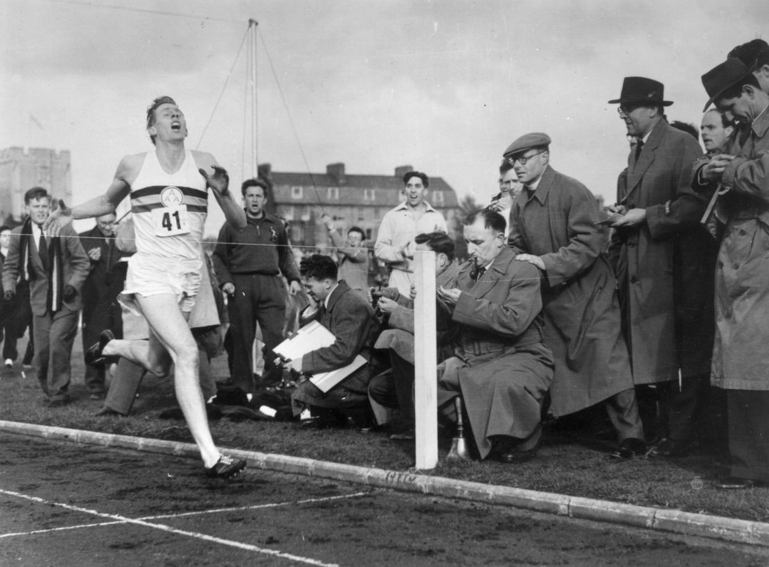 Bannister crosses the finish line and breaks the four-minute-mile barrier for the first time. 
