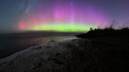 The Aurora Australis, also known as the Southern Lights, glow on the horizon over waters of Lake Ellesmere on the outskirts of Christchurch on April 24, 2023. (Photo by Sanka VIDANAGAMA / AFP) (Photo by SANKA VIDANAGAMA/AFP via Getty Images)