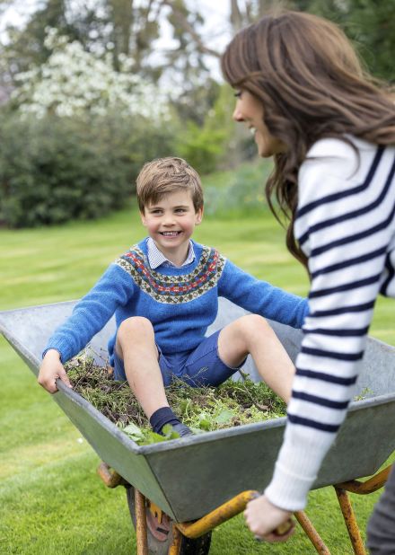 Prince Louis is pushed in a wheelbarrow by his mother in Windsor, England, in April 2023. The photo was released by Kensington Palace to mark Louis' fifth birthday.