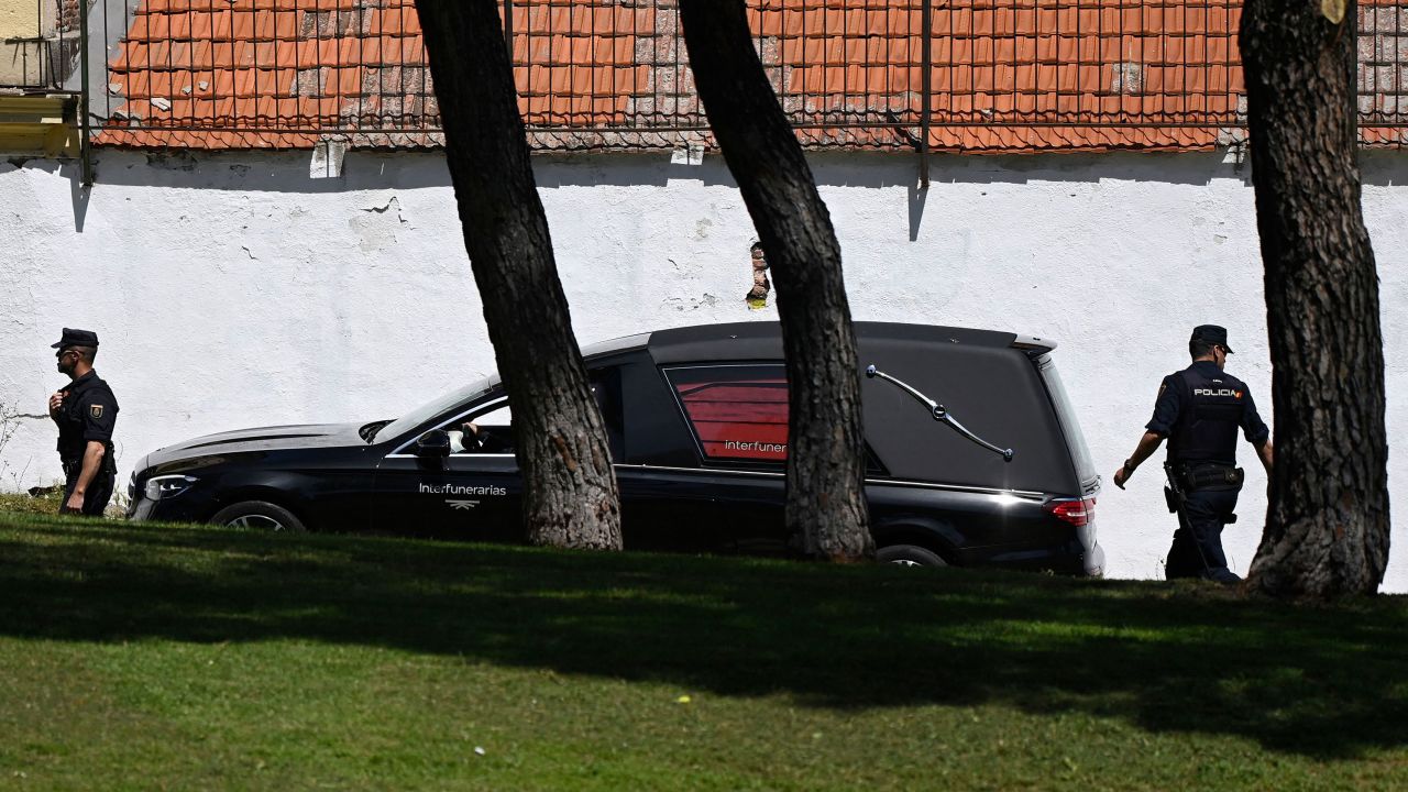 A hearse with the remains of José Antonio Primo de Rivera is escorted by police as it arrives at the San Isidro cemetery in Madrid.