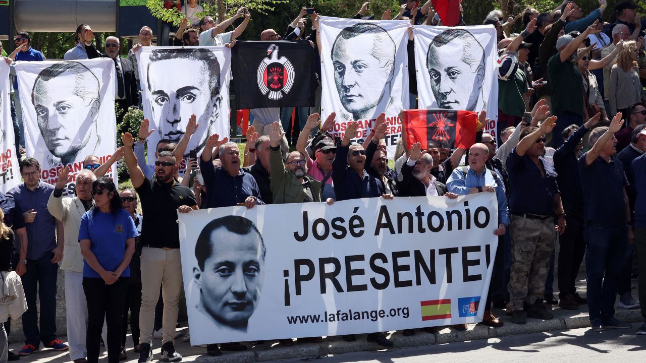 Sympathizers performing the fascist salute hold banners remembering the founder of Falange, José Antonio Primo de Rivera, outside the San Isidro cemetery in Madrid.