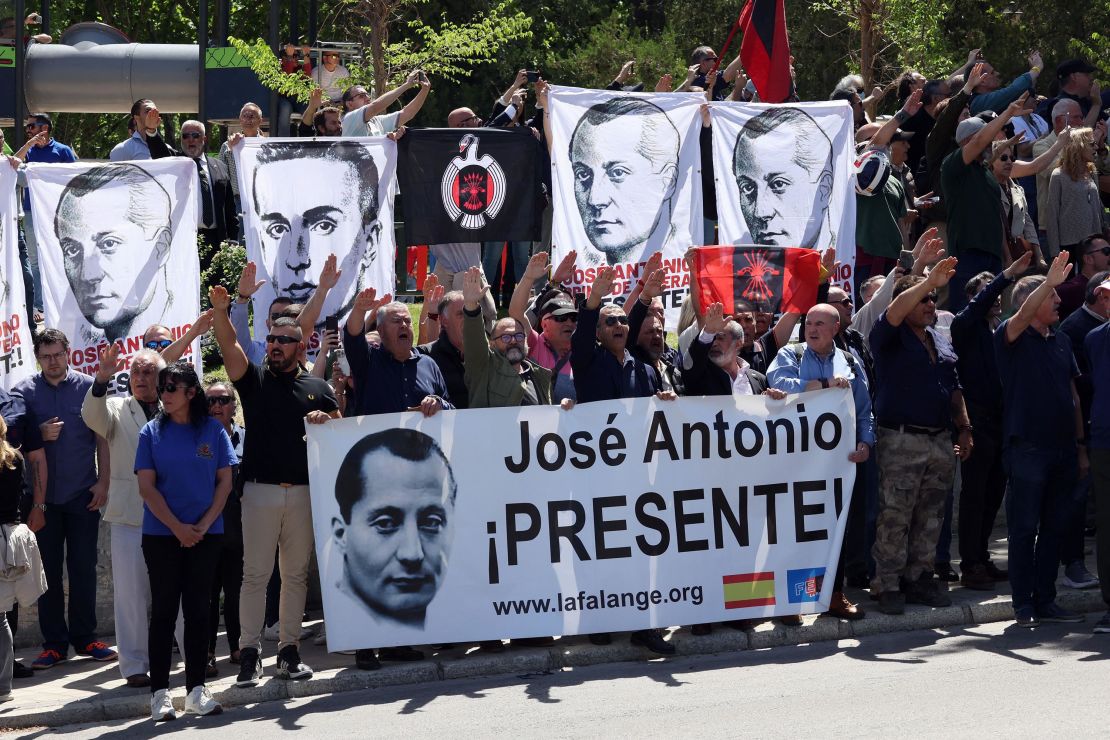 Sympathizers performing the fascist salute hold banners remembering the founder of Falange, José Antonio Primo de Rivera, outside the San Isidro cemetery in Madrid.