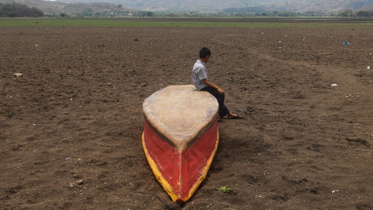 A boy on an abandoned boat on what is left of Lake Atescatempa, Guatemale, which dried up due to drought and high temperatures, in May 2017.